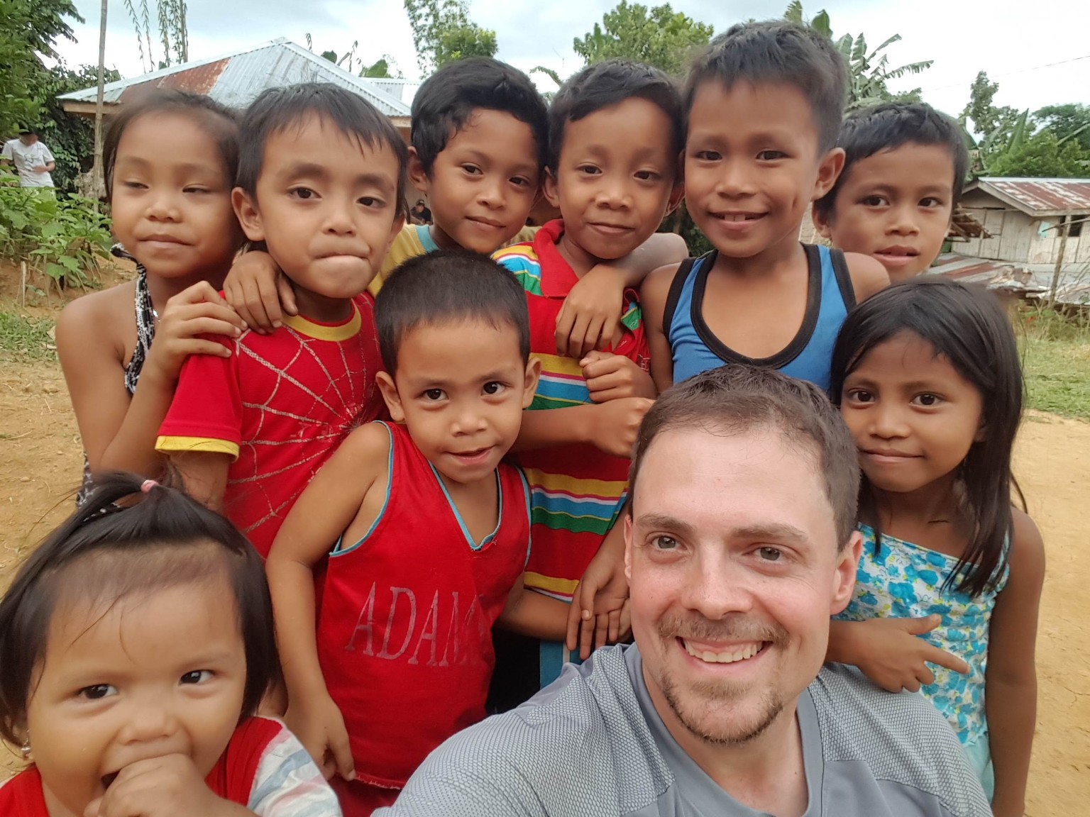 Bert Copple with children during a mission trip