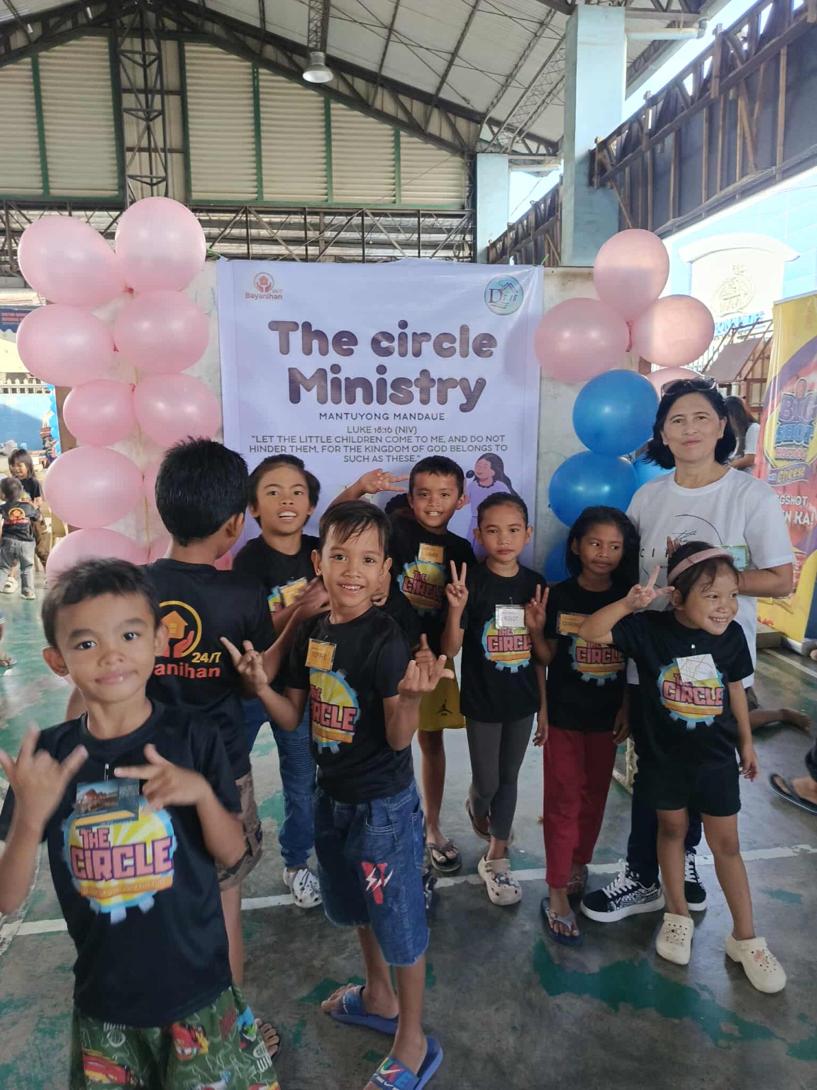Children and a volunteer at a Circle Ministry community event
