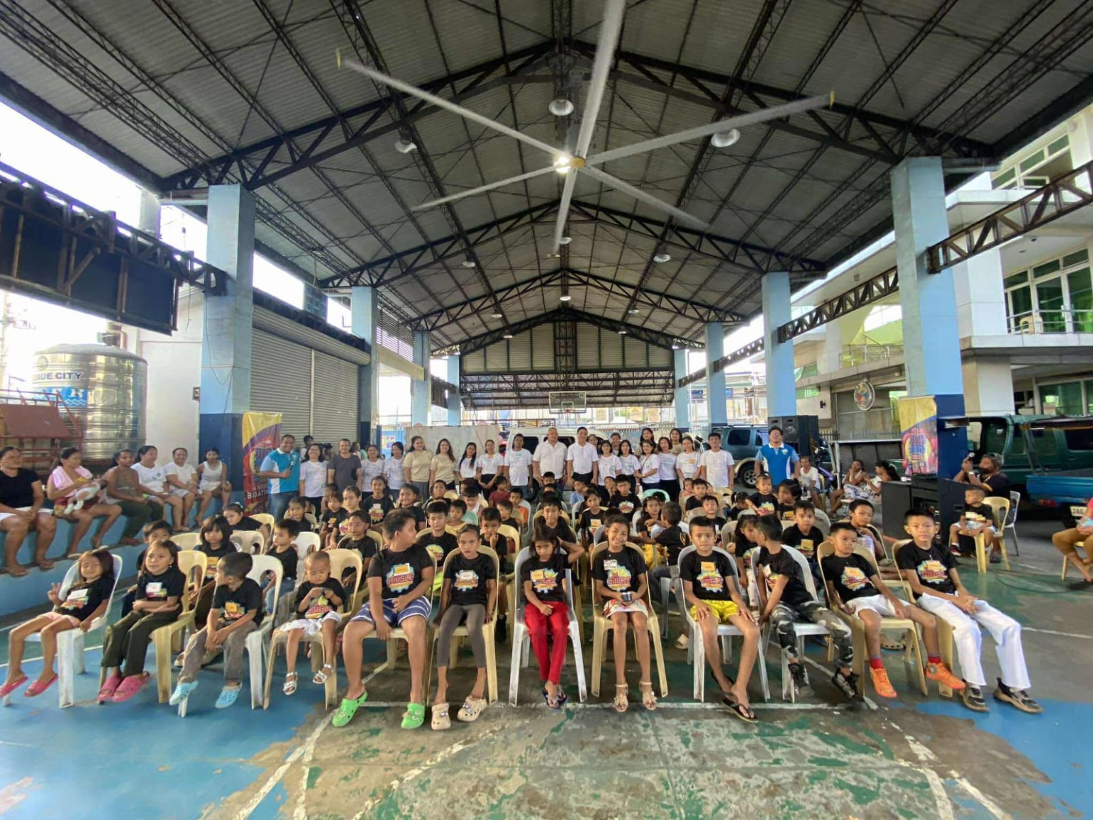 Children and volunteers gathered at a community outreach event in the Philippines